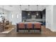 Gourmet kitchen featuring dark cabinets, pendant lighting, and a large center island with bar stools at 6722 N 9Th Dr, Phoenix, AZ 85013