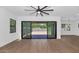 Bright open living space with expansive sliding doors to the backyard and ceiling fan at 6722 N 9Th Dr, Phoenix, AZ 85013