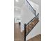 Beautiful staircase with black railings and light wood steps, leading to the upper levels of the home at 6722 N 9Th Dr, Phoenix, AZ 85013