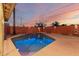 Stunning backyard pool illuminated at twilight, creating a serene oasis for relaxation and recreation at 6932 E Latham St, Scottsdale, AZ 85257