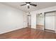Bedroom boasts hardwood floors, ceiling fan, adjacent bath and closet, providing comfort and convenience at 6932 E Latham St, Scottsdale, AZ 85257