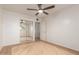 Bright bedroom features a ceiling fan, mirrored closet doors, and hardwood floors for a contemporary look at 6932 E Latham St, Scottsdale, AZ 85257