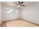 Light-filled bedroom with bright window and hardwood floors, offering a comfortable and airy atmosphere at 6932 E Latham St, Scottsdale, AZ 85257