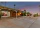 View of a covered carport with wooden beam details, and a landscaped front yard at 6932 E Latham St, Scottsdale, AZ 85257