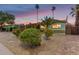Charming single-story home with desert landscaping and palm trees at dusk at 6932 E Latham St, Scottsdale, AZ 85257