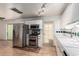 Efficient kitchen layout featuring stainless steel appliances and classic white cabinetry at 6932 E Latham St, Scottsdale, AZ 85257