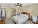 Cozy bedroom with neutral walls, wood furniture, and a view of the adjacent bathroom at 811 S 79Th Way, Mesa, AZ 85208