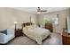 Comfortable bedroom features soft lighting, wood furniture, and a window with outside views at 811 S 79Th Way, Mesa, AZ 85208
