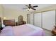Bedroom with an ensuite bathroom, slider closet, and furnishings at 811 S 79Th Way, Mesa, AZ 85208