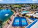Aerial view featuring a lake, a pool with lounge chairs, desert landscaping, and pickleball courts for recreation at 811 S 79Th Way, Mesa, AZ 85208