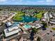 Aerial view of luxurious community amenities including a pool, hot tub, lake, tennis court, and golf course at 811 S 79Th Way, Mesa, AZ 85208