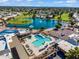 Aerial view of the community pool, lake, and golf course offering resort-style amenities to residents at 811 S 79Th Way, Mesa, AZ 85208