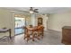 Bright dining room features a wood table set, ceiling fan, and a sliding glass door to the outside at 811 S 79Th Way, Mesa, AZ 85208
