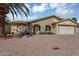 Inviting single-Gathering residence with arched entryway, two-car garage, and low maintenance desert landscaping at 811 S 79Th Way, Mesa, AZ 85208