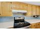 Modern kitchen showcasing stainless steel appliances, stylish backsplash, and ample cabinet space at 811 S 79Th Way, Mesa, AZ 85208