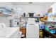 Bright laundry room with a washing machine, dryer, water heater, storage shelves, and ample space at 811 S 79Th Way, Mesa, AZ 85208