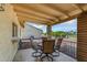 Covered patio with tiled floor, brick pillars, iron railing and outdoor seating at 811 S 79Th Way, Mesa, AZ 85208