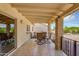 Covered patio with tiled floor, brick pillars, iron railing and outdoor seating at 811 S 79Th Way, Mesa, AZ 85208