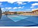 Outdoor pickleball court featuring blue court lines and a net with recreational buildings in the background at 811 S 79Th Way, Mesa, AZ 85208