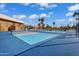 Bright blue pickleball court with crisp white lines located within a fenced enclosure near tropical palm trees at 811 S 79Th Way, Mesa, AZ 85208