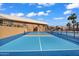 Community pickleball court with vibrant blue surfacing, surrounded by fencing and lush landscaping at 811 S 79Th Way, Mesa, AZ 85208
