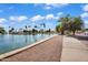 A tranquil pond lined by a sidewalk, palm trees, and mature trees offering a peaceful community amenity at 811 S 79Th Way, Mesa, AZ 85208