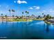 Beautiful community pond with a water fountain and lush palm trees surrounding the water front homes at 811 S 79Th Way, Mesa, AZ 85208