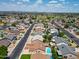 Neighborhood aerial view showcasing the community with mature trees and tidy streets near a golf course at 8943 W Sierra Vista Dr, Glendale, AZ 85305