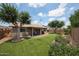 Spacious backyard with manicured lawn and covered patio at 8943 W Sierra Vista Dr, Glendale, AZ 85305