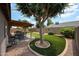 Covered patio with dining area and landscaped backyard with trees at 8943 W Sierra Vista Dr, Glendale, AZ 85305