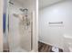 Bathroom featuring glass enclosed shower stall, and wood-look floors at 8943 W Sierra Vista Dr, Glendale, AZ 85305