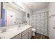 Bathroom featuring vanity, toilet, shower with curtain, and wood-look floors at 8943 W Sierra Vista Dr, Glendale, AZ 85305