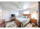 Cozy bedroom features a ceiling fan, a wood bed frame, and a floral area rug at 8943 W Sierra Vista Dr, Glendale, AZ 85305