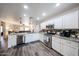 Modern kitchen with stainless steel appliances, white cabinets, and an open layout at 8943 W Sierra Vista Dr, Glendale, AZ 85305