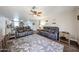 Spacious living room showcasing wood-look floors, ceiling fan and neutral-toned walls at 8943 W Sierra Vista Dr, Glendale, AZ 85305