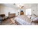 Main bedroom featuring wood-look floors and a ceiling fan, providing a cool retreat at 8943 W Sierra Vista Dr, Glendale, AZ 85305