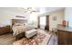 Bedroom featuring wood-look floors, ceiling fan and queen-size bed with upholstered storage bench at 8943 W Sierra Vista Dr, Glendale, AZ 85305