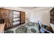 Office featuring wardrobe cabinet, desk, large rug, and wood-look flooring at 8943 W Sierra Vista Dr, Glendale, AZ 85305
