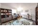 Office featuring built in shelving, desk, large rug, and wood-look flooring at 8943 W Sierra Vista Dr, Glendale, AZ 85305