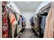 Large walk-in closet features long racks of hanging clothing and wood-look floors at 8943 W Sierra Vista Dr, Glendale, AZ 85305