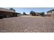 A spacious fenced backyard has low-maintenance landscaping and backs to a covered patio at 9243 W Palmer Dr, Peoria, AZ 85345