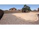 A large fenced backyard features low-maintenance landscaping and ample space for a custom design at 9243 W Palmer Dr, Peoria, AZ 85345