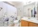 Bathroom featuring a shower-tub combination, toilet, vanity with sink, and neutral tile flooring at 9243 W Palmer Dr, Peoria, AZ 85345