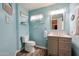 Bright bathroom features a stylish vanity, wood-look floors, and charming beach-themed decor at 9243 W Palmer Dr, Peoria, AZ 85345