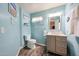 Bright bathroom features a stylish vanity, wood-look floors, and charming beach-themed decor at 9243 W Palmer Dr, Peoria, AZ 85345