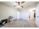 Bright bedroom with large windows, ceiling fan, carpet floors, and a built in white storage cabinet at 9243 W Palmer Dr, Peoria, AZ 85345