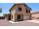 Two-story stucco home with a two-car garage, desert landscaping, and a covered front porch at 9243 W Palmer Dr, Peoria, AZ 85345