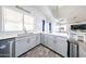 Open kitchen featuring wood-look tile flooring, quartz countertops, stainless steel appliances and a center island at 9243 W Palmer Dr, Peoria, AZ 85345