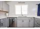 Bright kitchen featuring stainless steel appliances, a sink, and attractive cabinets and countertops at 9243 W Palmer Dr, Peoria, AZ 85345