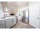 Open kitchen features stainless steel refrigerator, gray cabinets, and dining area at 9243 W Palmer Dr, Peoria, AZ 85345